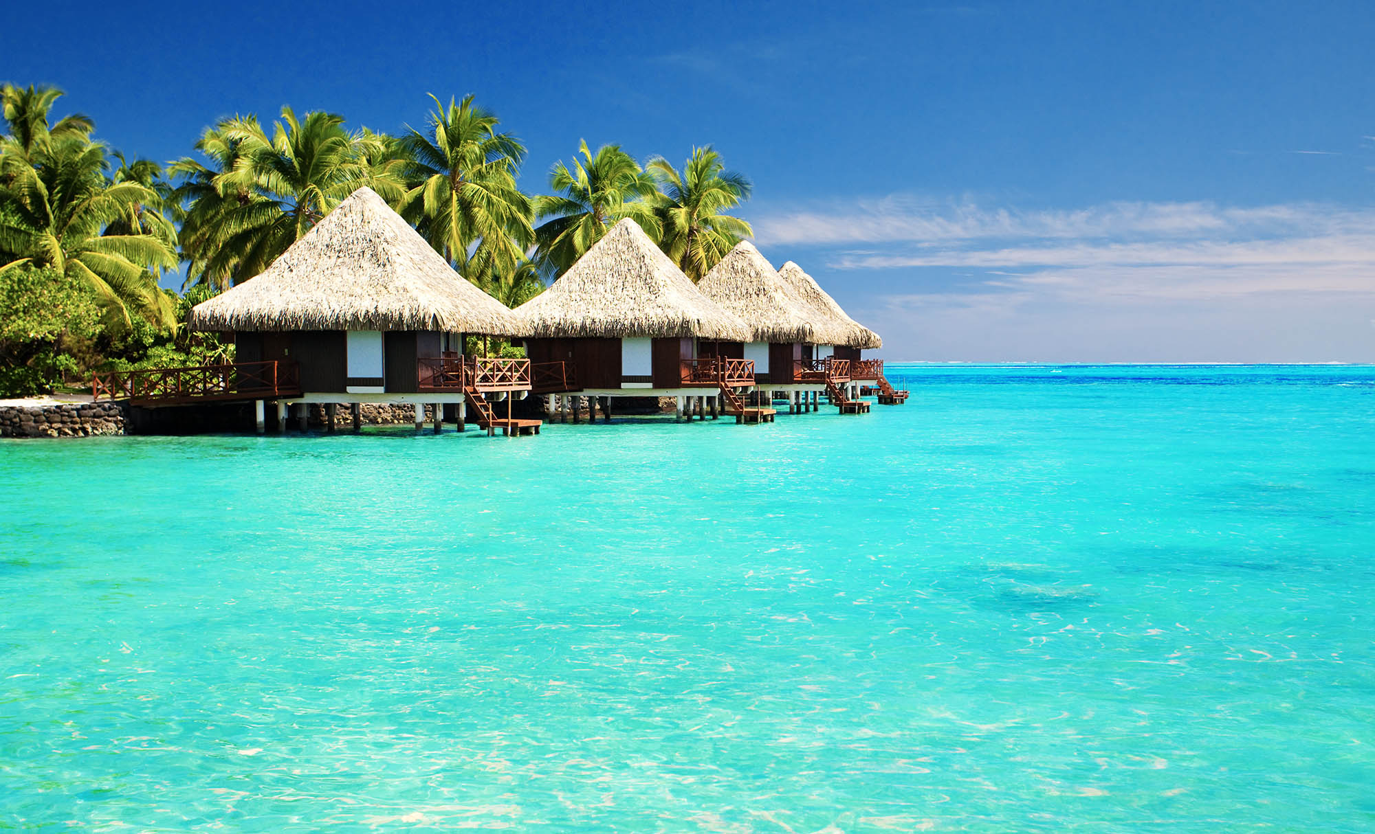 3 huts on a blue ocean